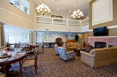 Well-decorated common area with seating and tables