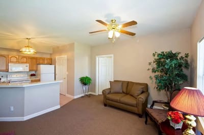 Cozy interior of a resident's room with a couch and kitchenette