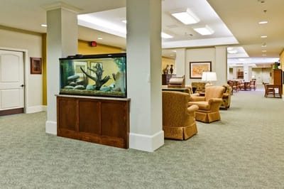 Interior view of a common area with seating and an aquarium