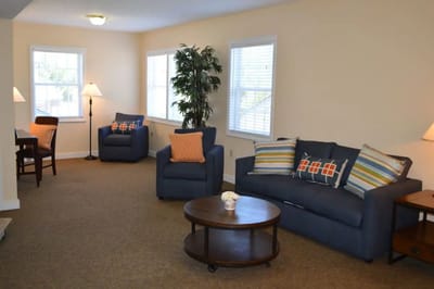 Cozy interior lounge area with seating and lamps
