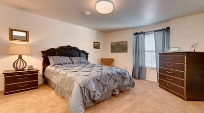 Cozy private resident room with bed and furniture