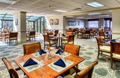Dining area set up for residents with tables and chairs