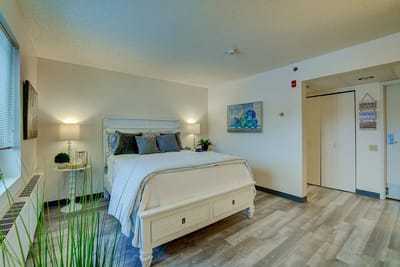 Brightly decorated private resident room with a bed