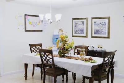 Dining area decorated for autumn with floral centerpiece