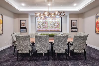 Well-decorated meeting room with a large table and art