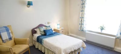 Brightly decorated single resident room with natural light