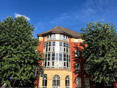 Exterior view of Tower Bridge Care Home surrounded by trees