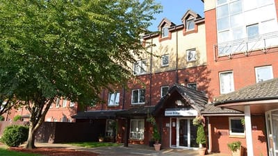 Front exterior of Tower Bridge Care Home with landscaped area