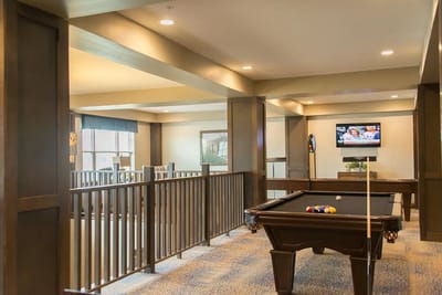 Common area with a billiards table and TV