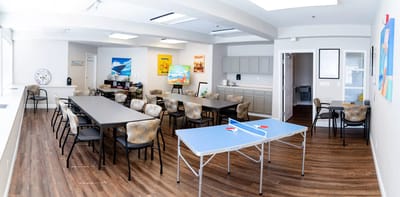 Bright activity room with tables and decor