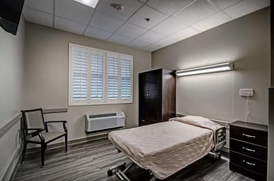 A well-furnished patient room in a nursing facility