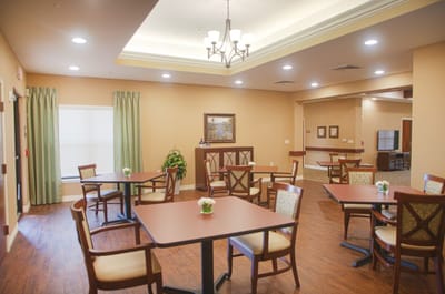 Dining area with tables and chairs in a cozy room