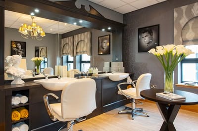 Beauty salon area with styling chairs and decor