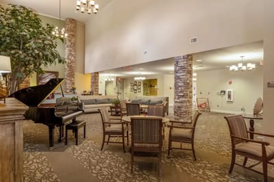 Lounge area with piano and seating for residents