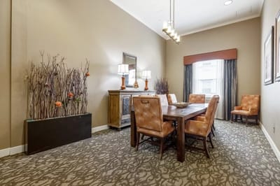 A well-decorated dining area with a table and chairs