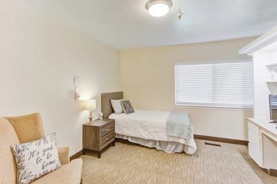Cozy private resident room with bed and furniture