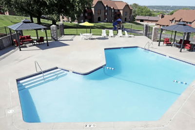 Swimming pool area with lounge chairs and umbrellas