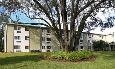 Exterior view of a senior living facility with landscaping