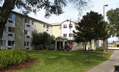 Exterior view of the facility with residents outside