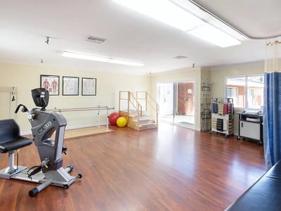 Bright therapy room with exercise equipment