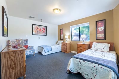 Cozy private bedroom with two beds and artwork