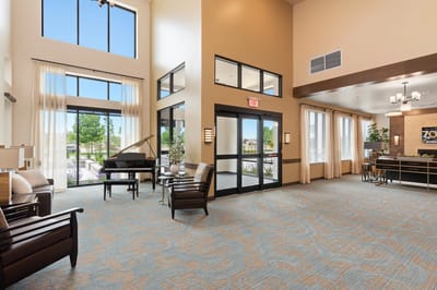 Bright common area with seating and piano