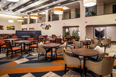 Common area with tables and chairs in a stylish setting