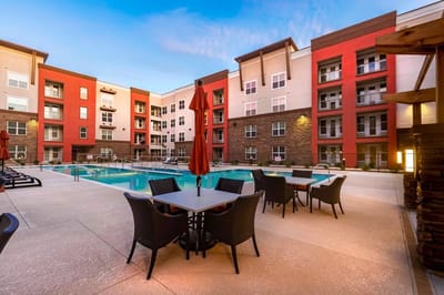 Outdoor pool area with seating and umbrellas
