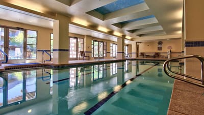 Indoor swimming pool area with lounge chairs