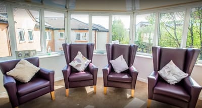 Cozy seating area with large windows in a common room