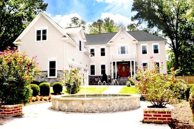 Exterior view of Vienna Manor Assisted Living with a fountain