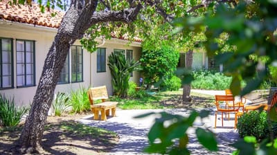 Outdoor seating area with plants and benches