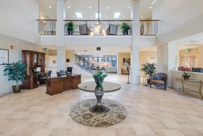 Bright lobby area with a reception desk and seating