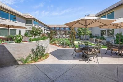 Garden area with tables and umbrellas in a courtyard
