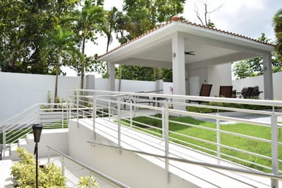 Outdoor seating area with accessible walkways and greenery