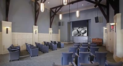 Interior of an activity room with seating and a screen