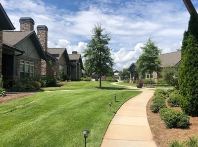 Beautifully landscaped outdoor pathway in a senior living community