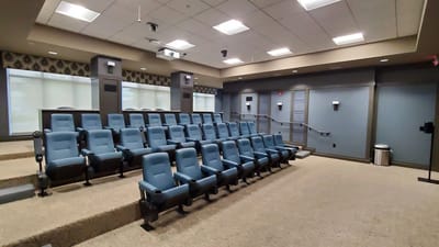 Interior photo of a quiet theater room with seating