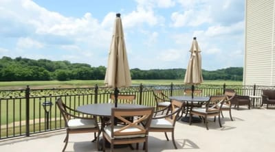 Outdoor patio with tables and umbrellas overlooking landscape
