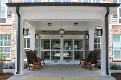 Covered entrance with rocking chairs at the facility