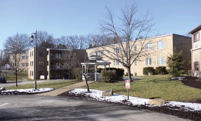 Exterior view of a senior living facility with landscaping
