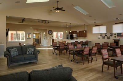 Interior of a common area with seating and dining setup