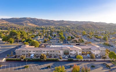 Aerial view of a senior living facility with mountains in the background