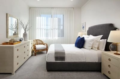 Bright, well-furnished resident bedroom with natural light