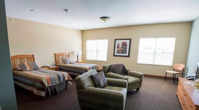 Cozy interior of a resident room set up with two beds
