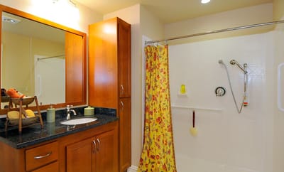 Bright bathroom with modern fixtures and yellow shower curtain