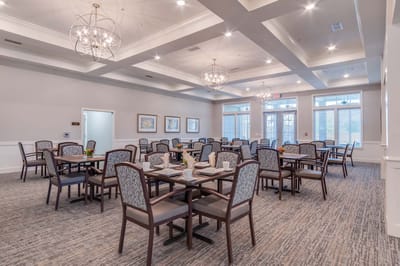 Dining room with elegantly set tables and chairs