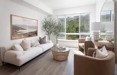 Bright common area with modern furniture and large windows