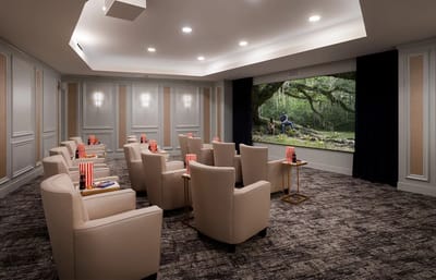 Cozy movie room with comfortable seating and a large screen
