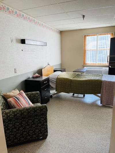 Private resident room with a bed and seating area